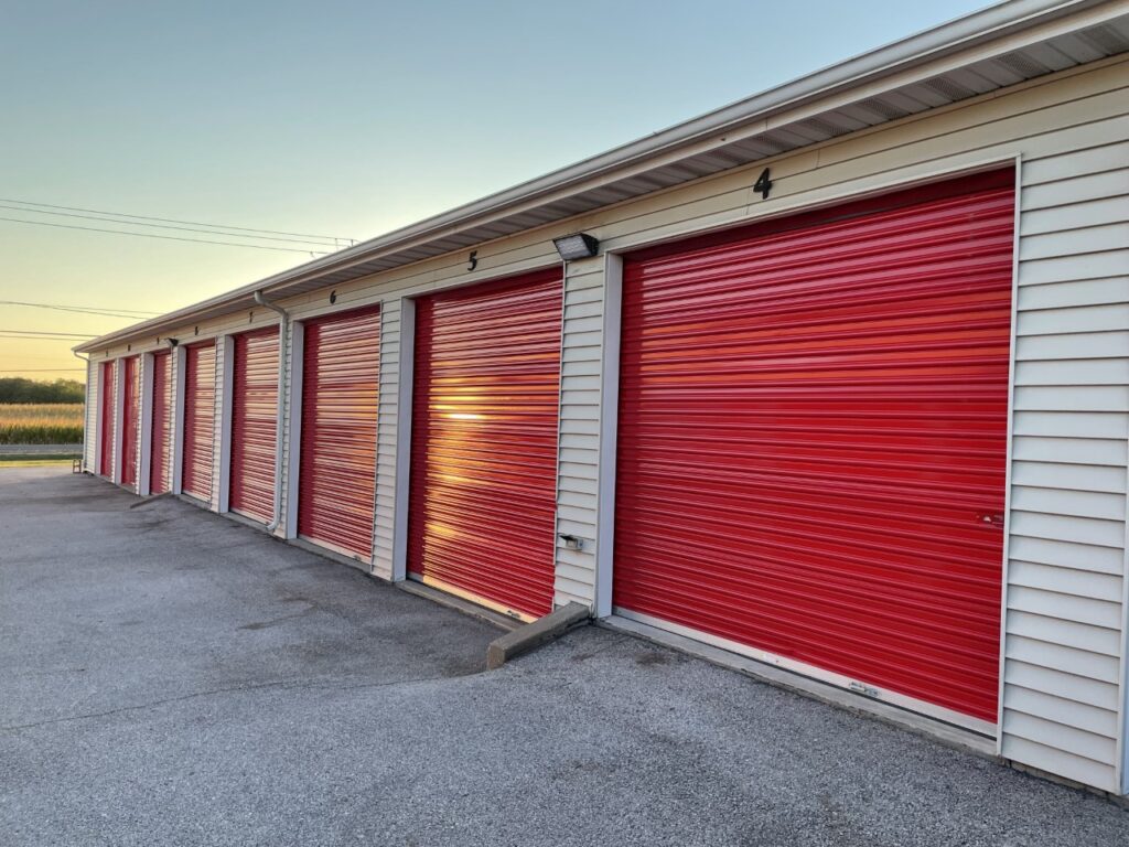 Row of storage units with red roll-up doors at Red Barn Storage in Davenport, Iowa