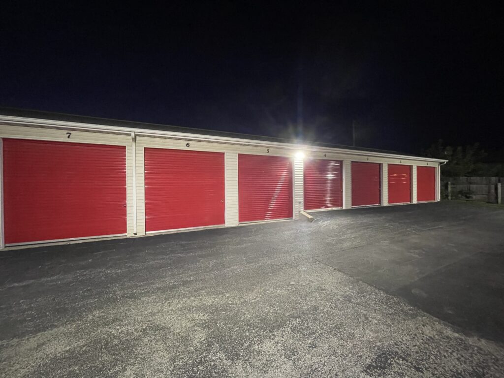 Drive-up Storage Units at Red Barn Storage in Davenport, Iowa at night with paved driveway (Units 1 to 7)