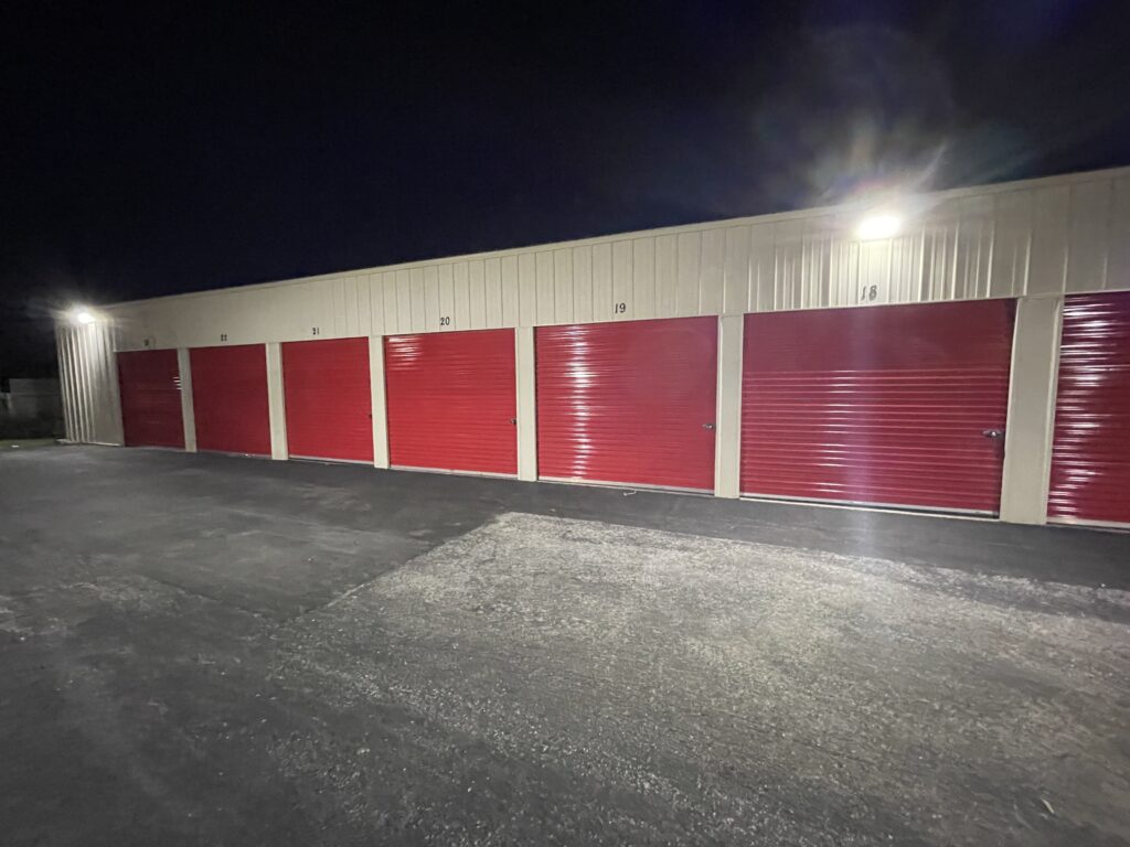 Drive-up Storage Units at Red Barn Storage in Davenport, Iowa at night with paved driveway (Units 18 to 23)