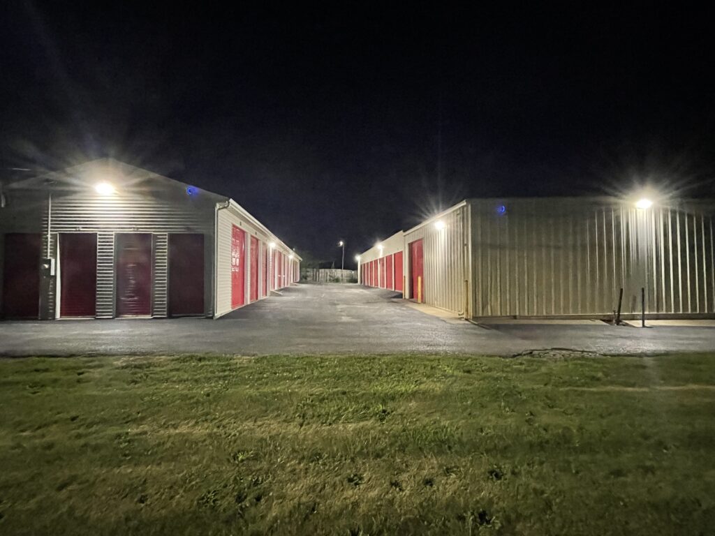 Drive-up Storage Units at Red Barn Storage in Davenport, Iowa at night with paved driveway (from the road)