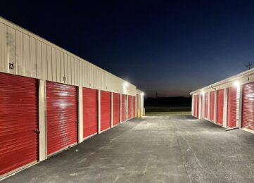 Drive-up Storage Units at Red Barn Storage in Davenport, Iowa at night with paved driveway.