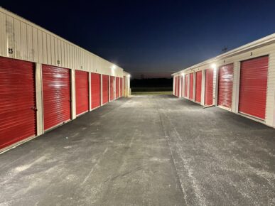 Drive-up Storage Units at Red Barn Storage in Davenport, Iowa at night with paved driveway.