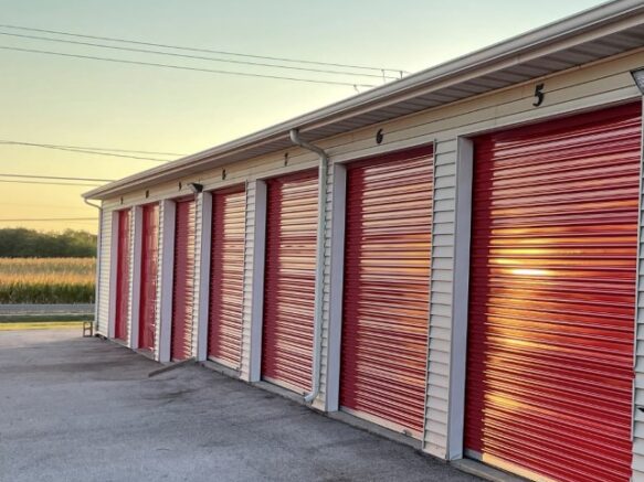 Row of storage units with red roll-up doors at Red Barn Storage in Davenport, Iowa